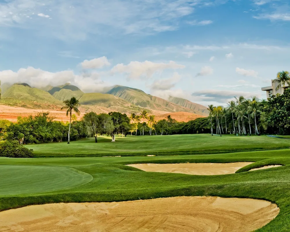 Golf course with sand bunkers and mountain backdrop at Hyatt Regency Maui Resort & Spa.
