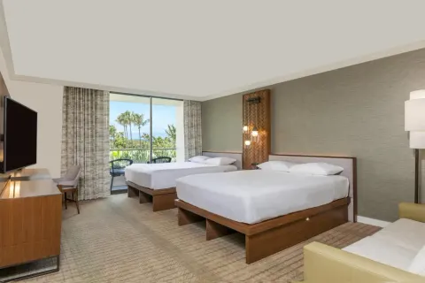 Two queen beds guest room with balcony view at Hyatt Regency Maui Resort & Spa.