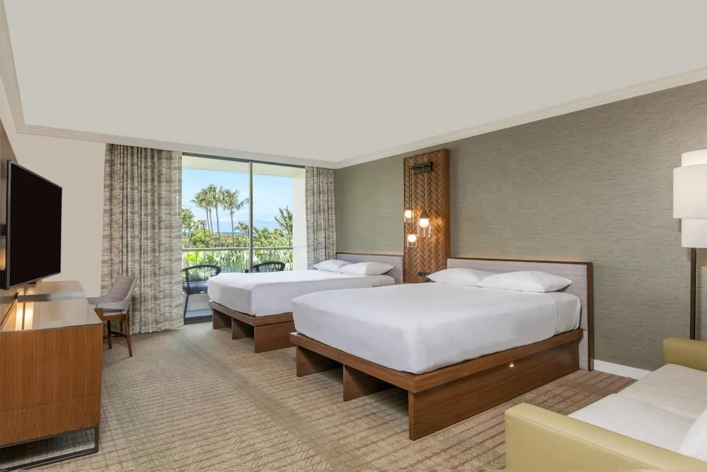 Two queen beds guest room with balcony view at Hyatt Regency Maui Resort & Spa.