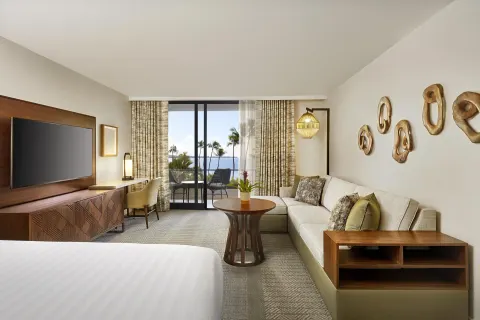 Guest room sitting area with ocean-view balcony at Hyatt Regency Maui Resort & Spa.