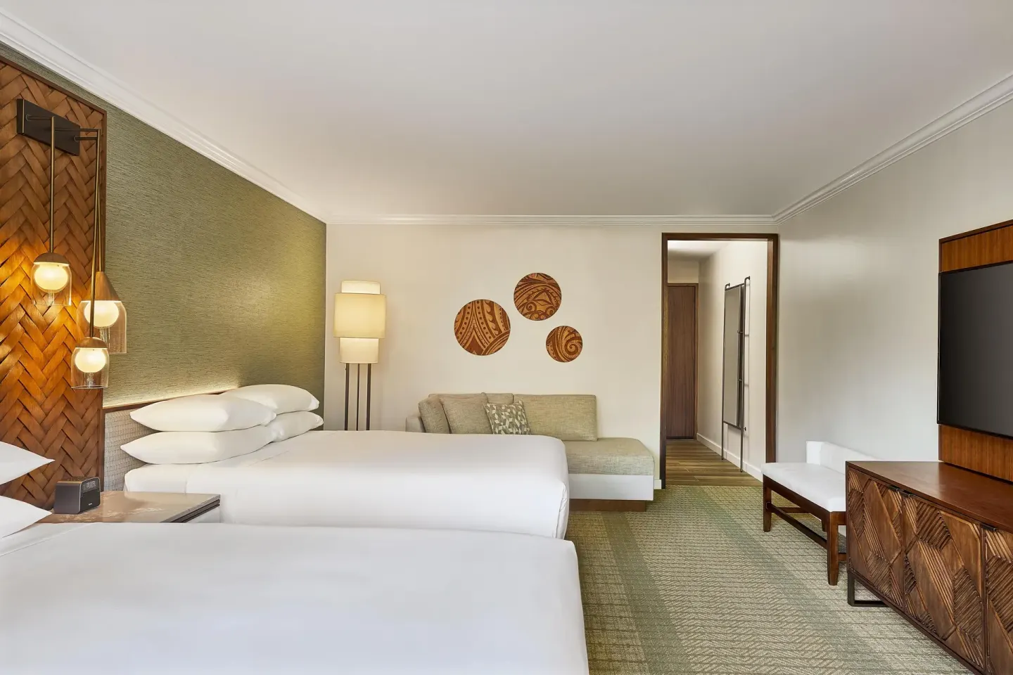 Two-bed guest room with sofa and wall-mounted TV at Hyatt Regency Maui Resort & Spa.