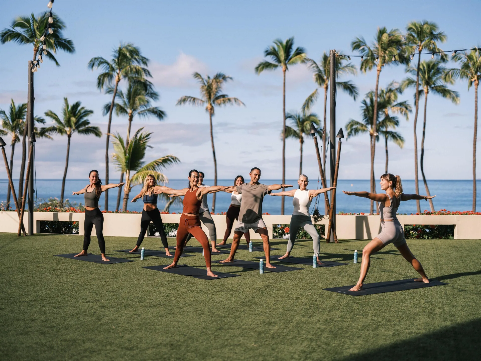Outdoor yoga class on a lawn by the ocean at Hyatt Regency Maui Resort & Spa.