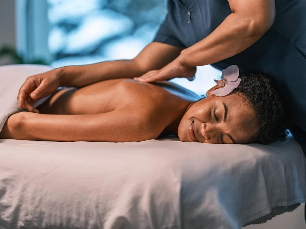 Close-up of a spa massage with a flower behind the guest's ear at Hyatt Regency Maui Resort & Spa.