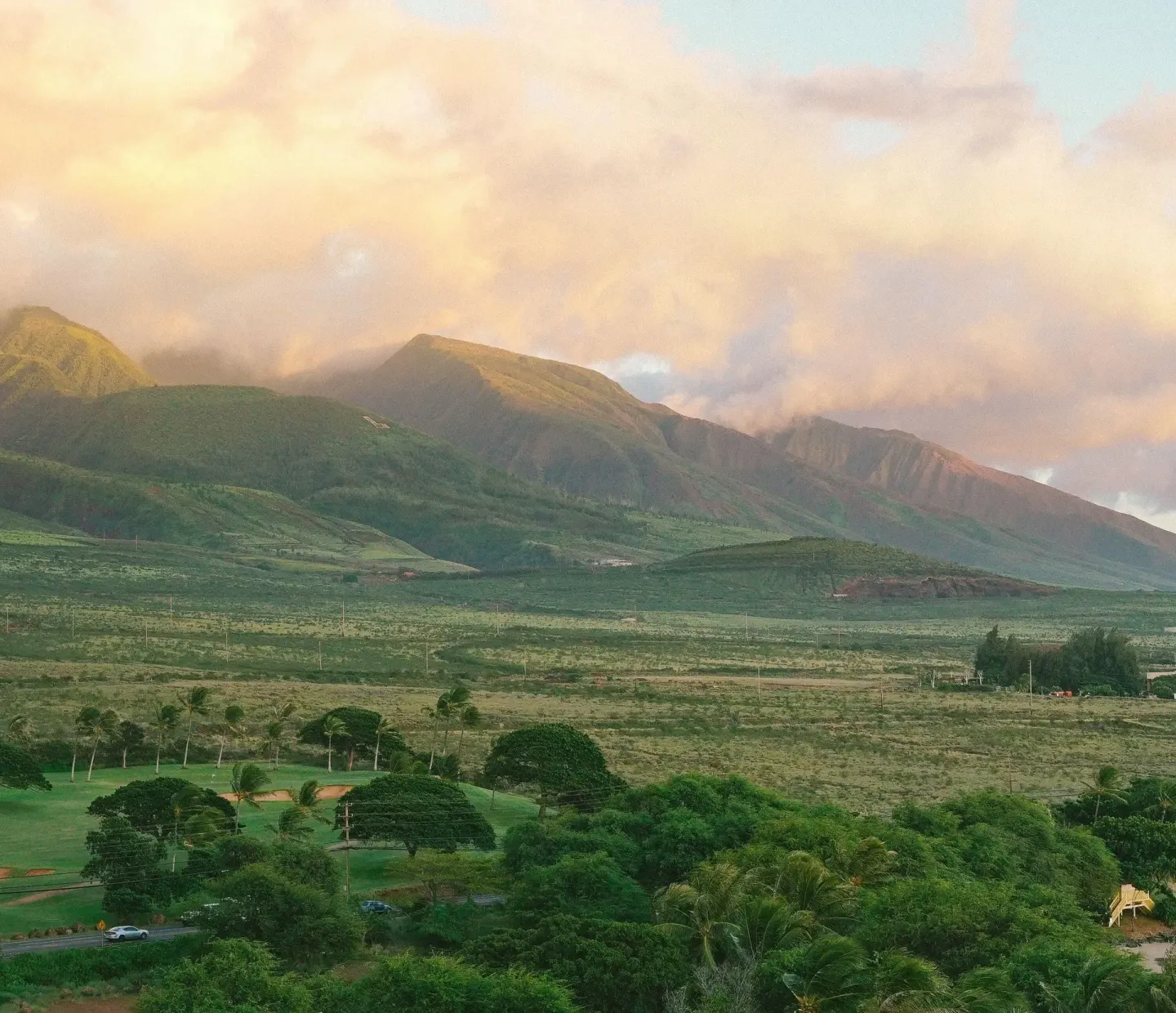 West Maui mountain landscape near Hyatt Regency Maui Resort & Spa under glowing clouds.