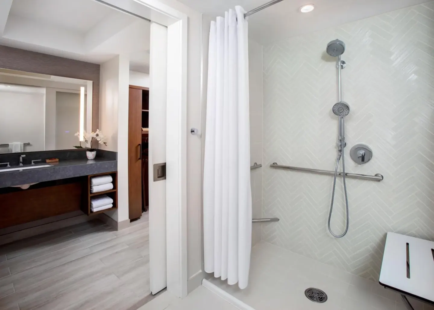 Accessible shower with grab bars beside the vanity at Hyatt Regency Maui Resort & Spa.