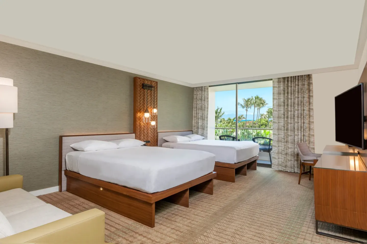 Partial ocean view room with two beds and balcony at Hyatt Regency Maui Resort & Spa.