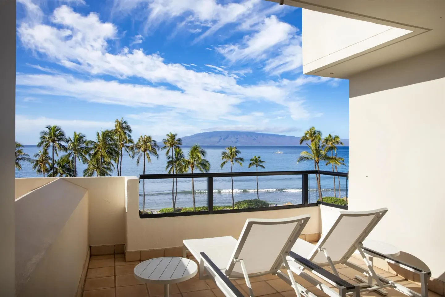 Ocean-view balcony with lounge chairs at Hyatt Regency Maui Resort & Spa.