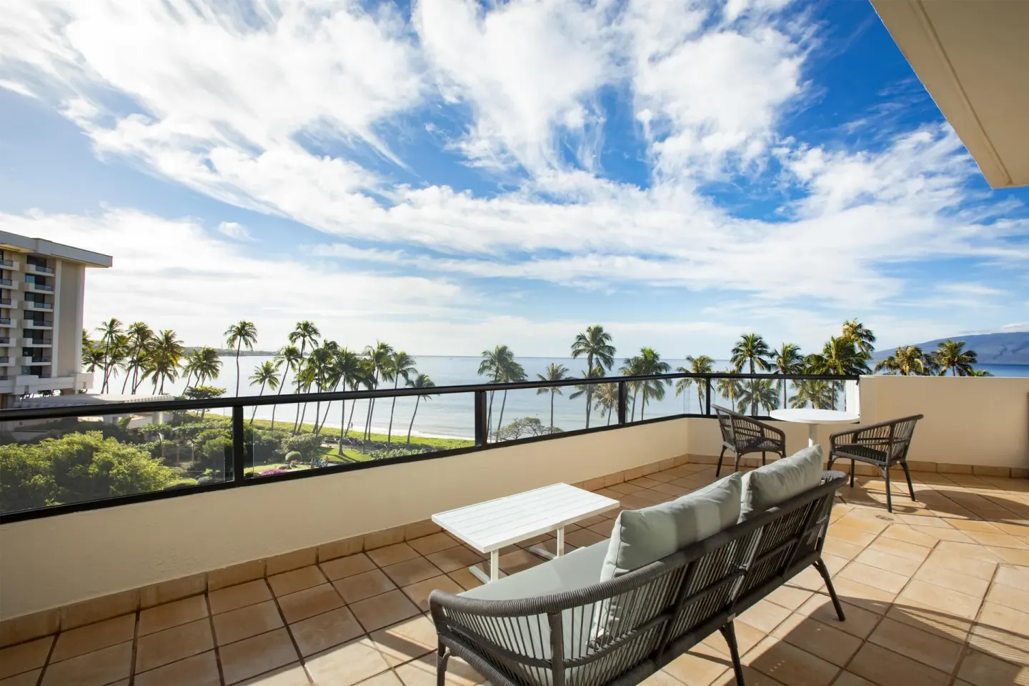 Large ocean-view corner balcony with seating at Hyatt Regency Maui Resort & Spa.