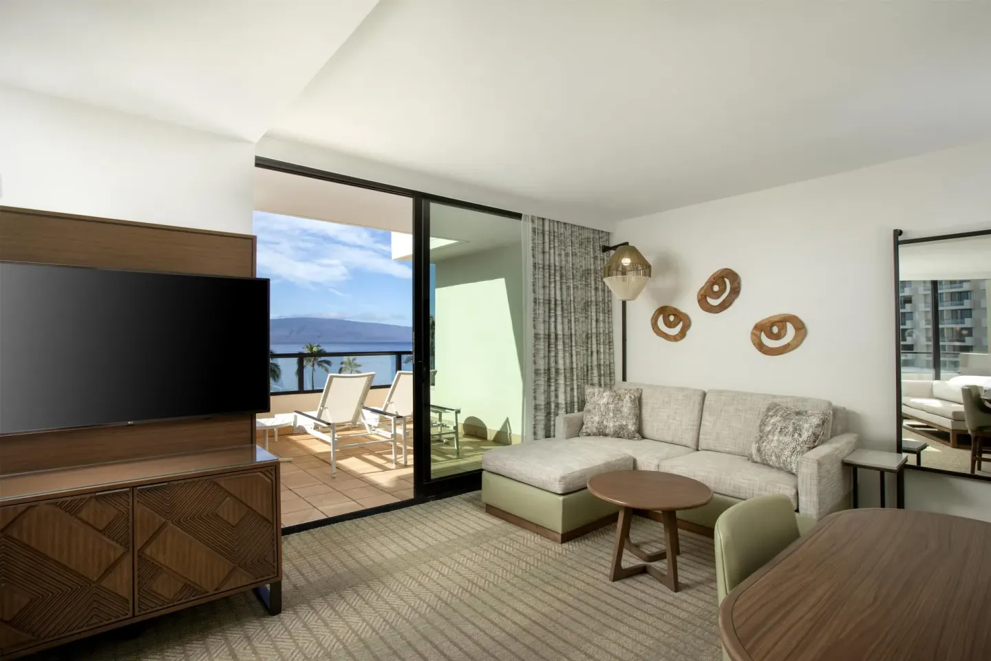 Sofa bed seating area beside an ocean-view balcony at Hyatt Regency Maui Resort & Spa.