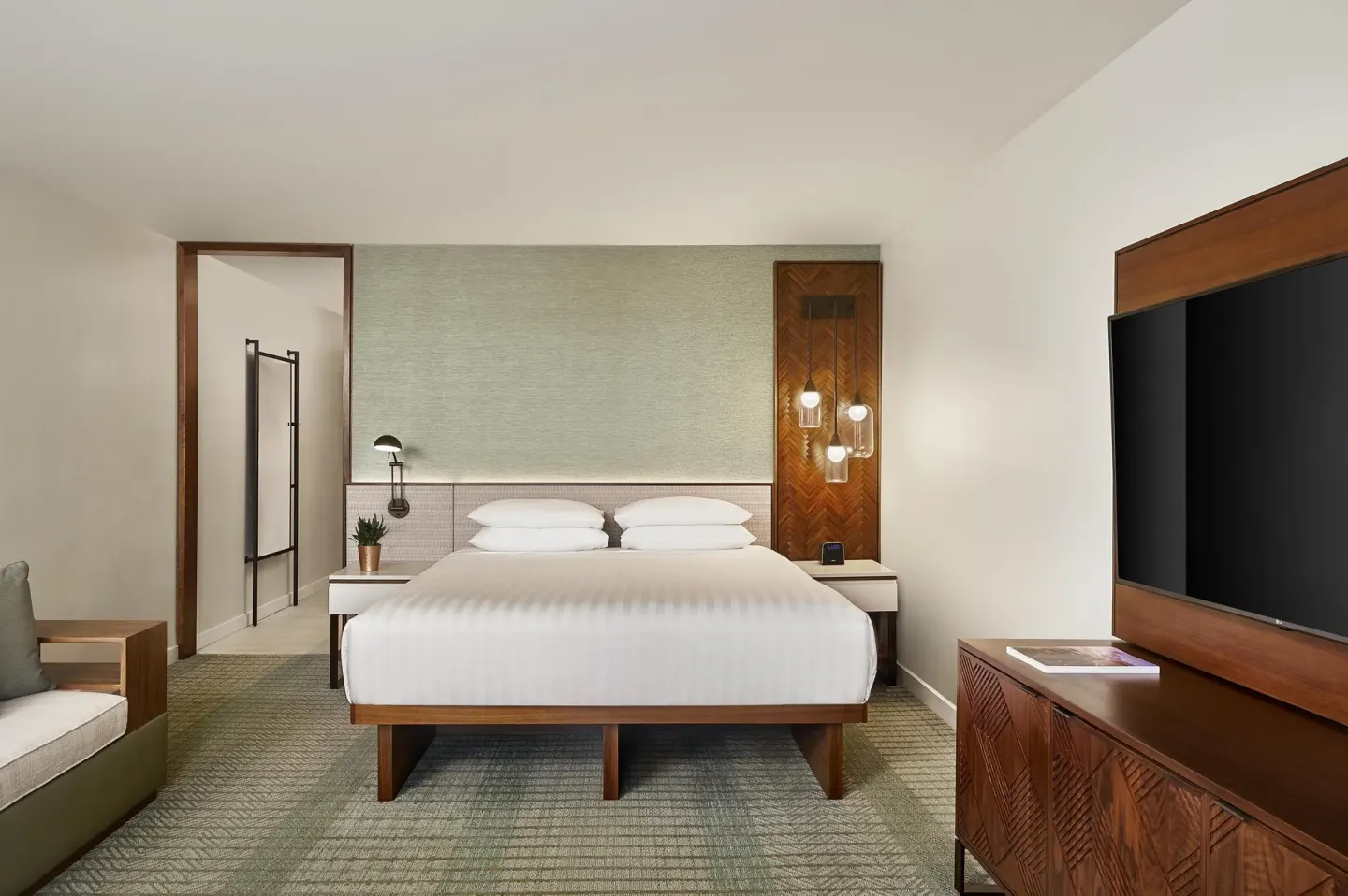 Room with king bed, sofa bed, and wall-mounted TV at Hyatt Regency Maui Resort & Spa.