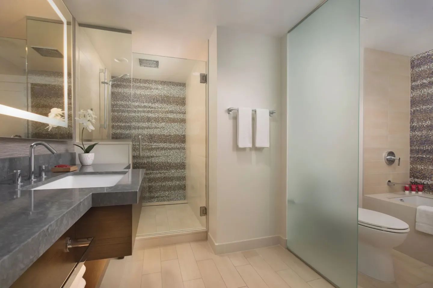Oceanfront suite bathroom with vanity, shower, and tub at Hyatt Regency Maui Resort & Spa.