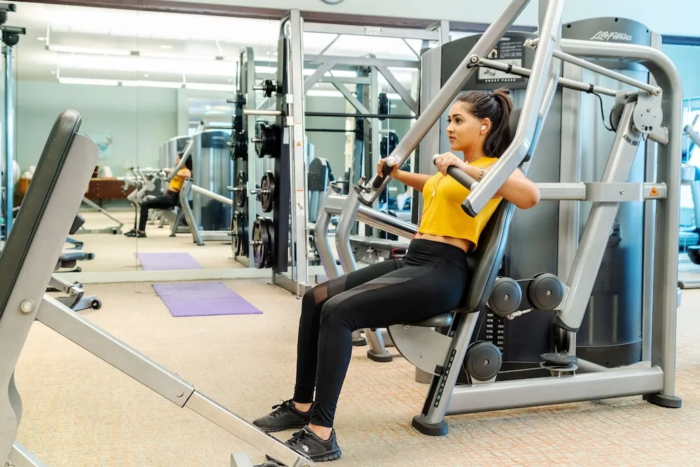 Guest using a strength machine in the fitness center at Hyatt Regency Trinidad.