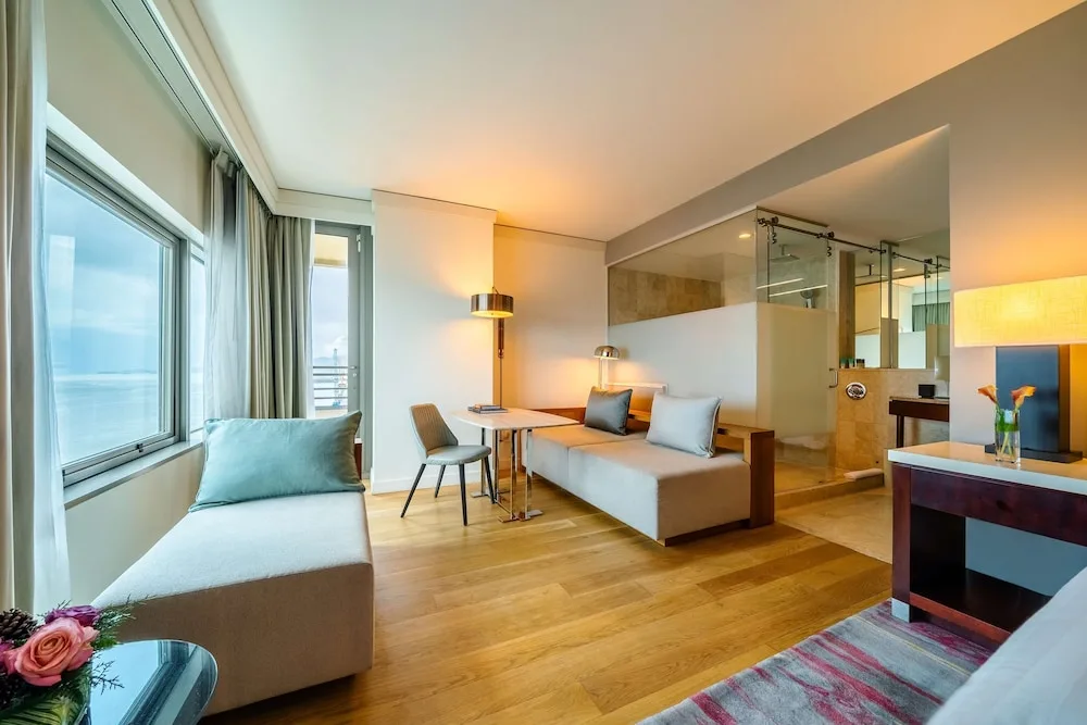 Ocean-view guest room with lounge seating and open bathroom at Hyatt Regency Trinidad.