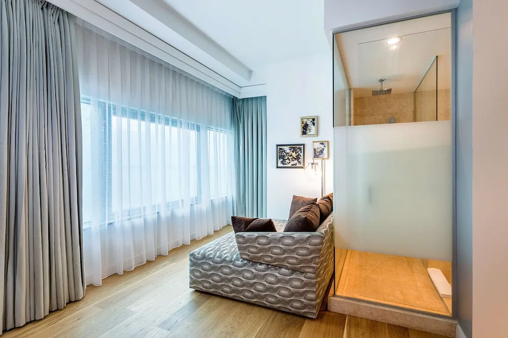 Guest room sitting area beside a glass shower at Hyatt Regency Trinidad.