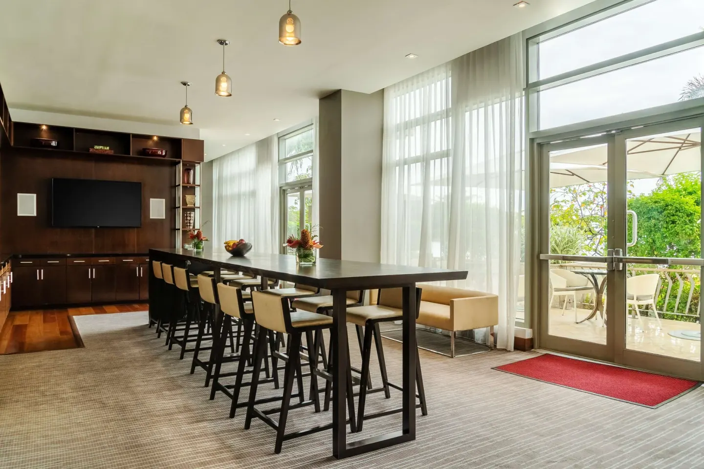Bright lounge with high table seating and terrace doors at Hyatt Regency Trinidad.