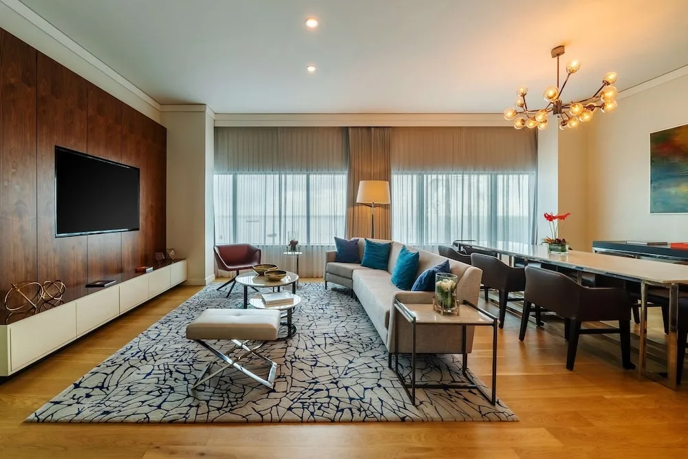 Suite living room with sofa, dining table and TV at Hyatt Regency Trinidad.