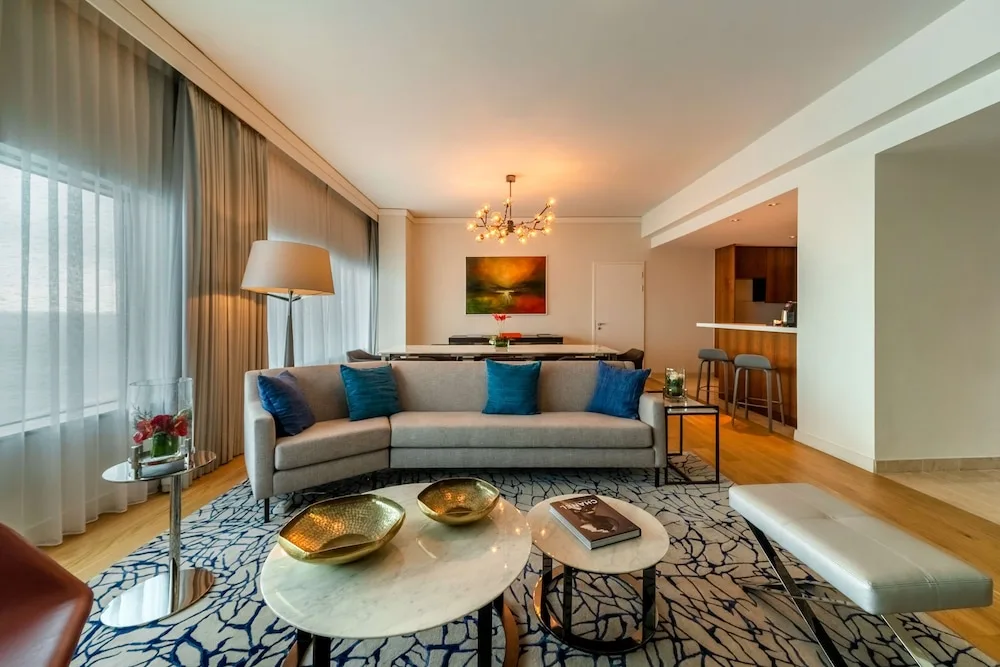 Suite seating area with sofa, coffee tables and bar counter at Hyatt Regency Trinidad.