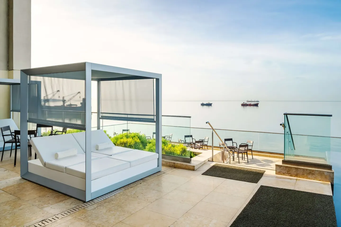 Outdoor terrace daybed overlooking the waterfront at Hyatt Regency Trinidad.