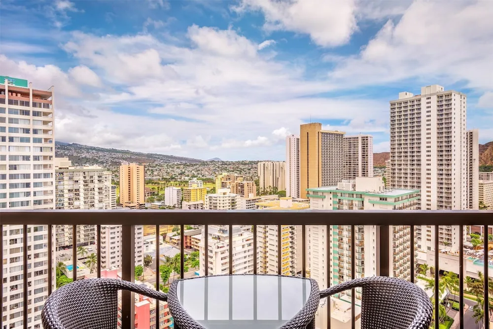 Balcony chairs overlooking Waikiki high-rises at Hyatt Regency Waikiki Beach Resort & Spa.