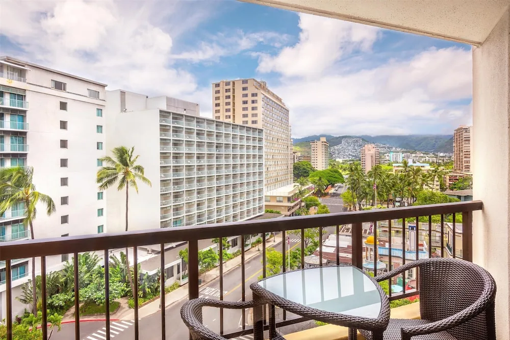 City-view balcony with table and chairs at Hyatt Regency Waikiki Beach Resort & Spa.