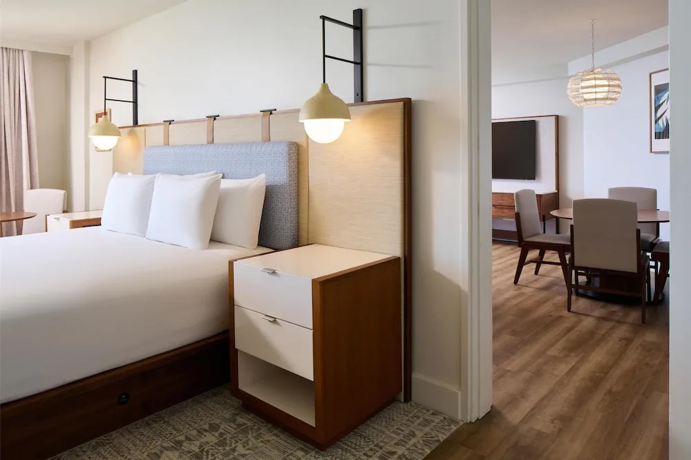 King bed beside an adjoining dining area at Hyatt Regency Waikiki Beach Resort & Spa.
