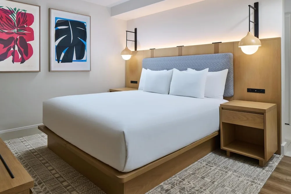 King bed with tropical artwork at Hyatt Regency Waikiki Beach Resort & Spa.