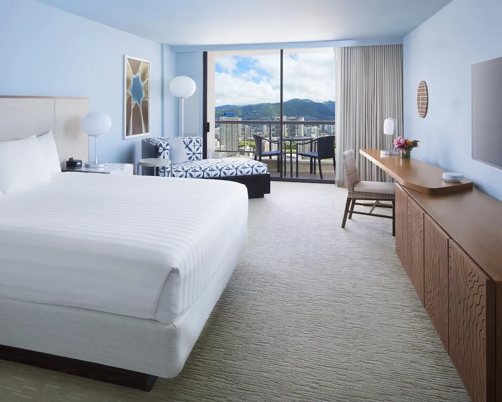 King guest room with mountain-view balcony at Hyatt Regency Waikiki Beach Resort & Spa.
