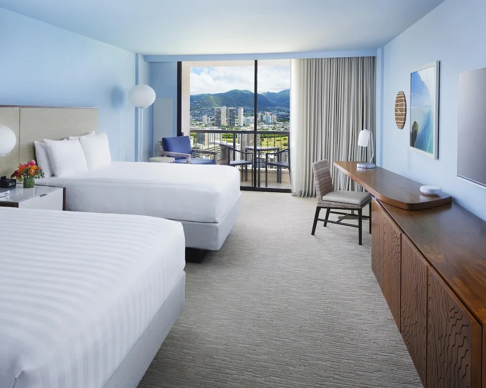 Two-bed guest room with mountain-view balcony at Hyatt Regency Waikiki Beach Resort & Spa.