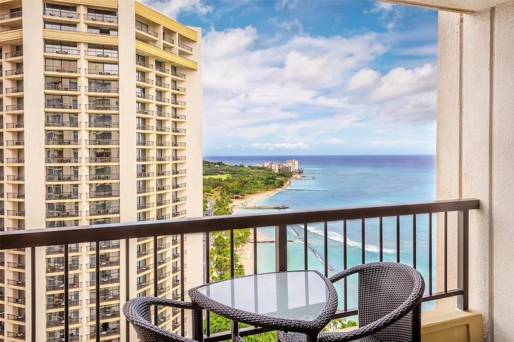 Ocean-view balcony with wicker chairs at Hyatt Regency Waikiki Beach Resort & Spa.