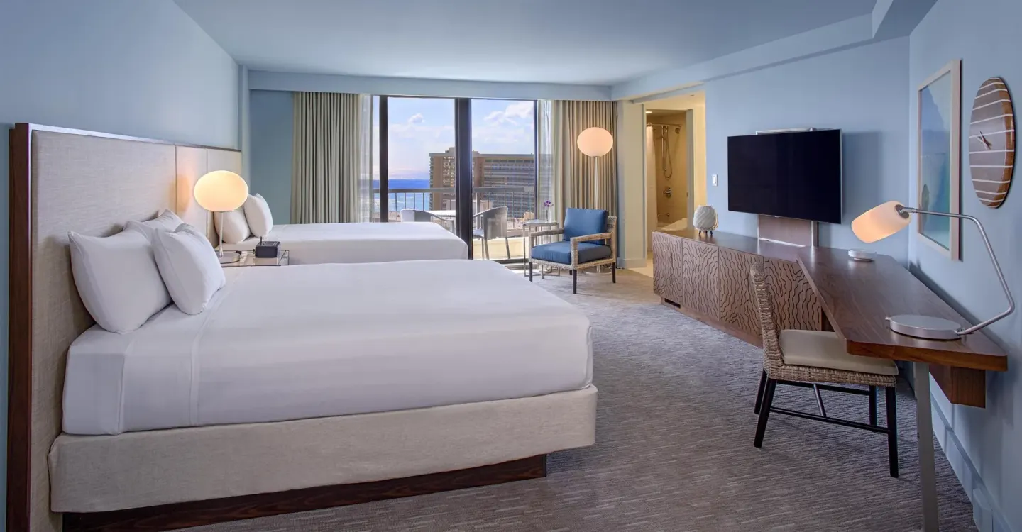 Two-bed guest room with ocean-view balcony at Hyatt Regency Waikiki Beach Resort & Spa.