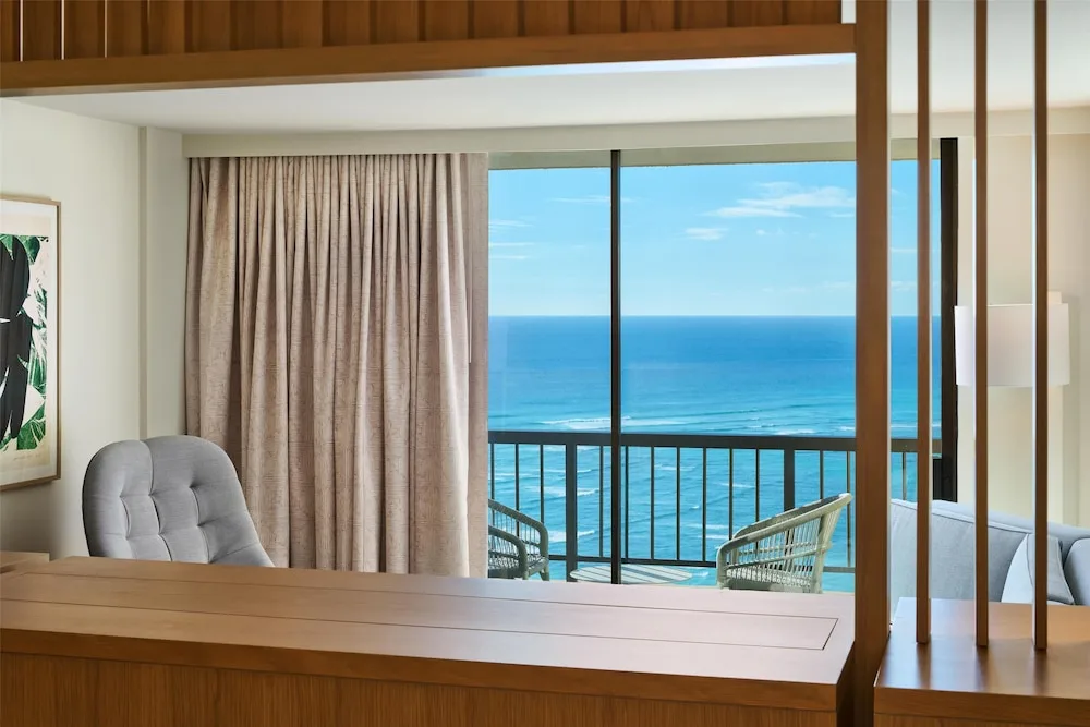 Suite sitting area with balcony ocean view at Hyatt Regency Waikiki Beach Resort & Spa.