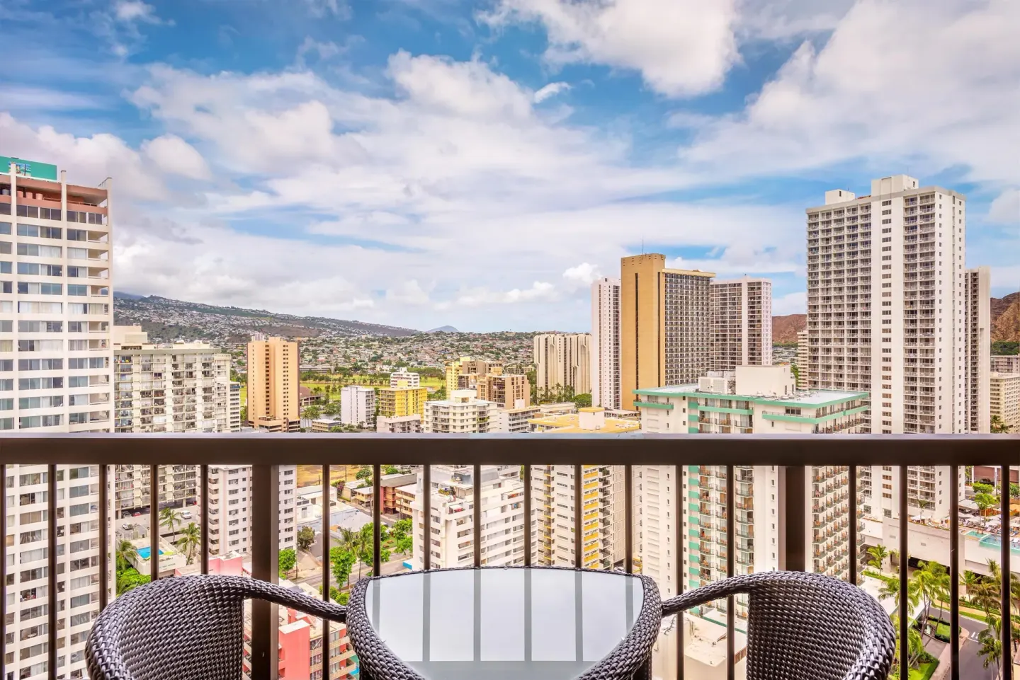 Balcony seating with Waikiki city and mountain views at Hyatt Regency Waikiki Beach Resort & Spa.