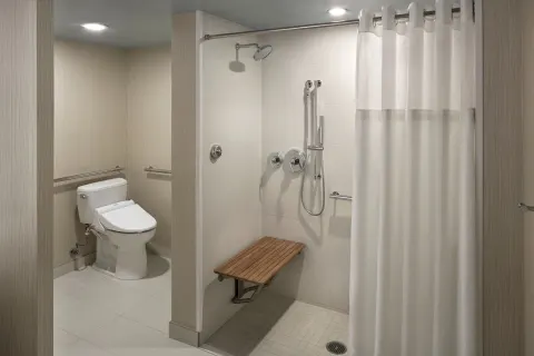 Accessible room bathroom with roll-in shower at Hyatt Regency Waikiki Beach Resort & Spa.