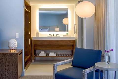 Waikiki View room vanity and sitting area at Hyatt Regency Waikiki Beach Resort & Spa.