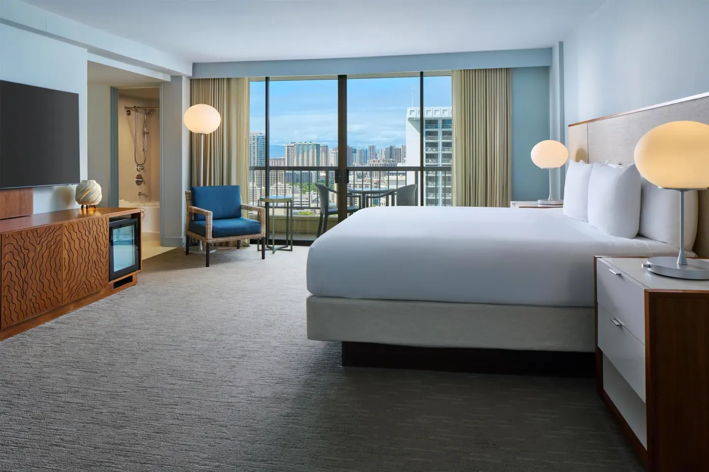 Waikiki view one-bedroom suite with king bed at Hyatt Regency Waikiki Beach Resort & Spa.