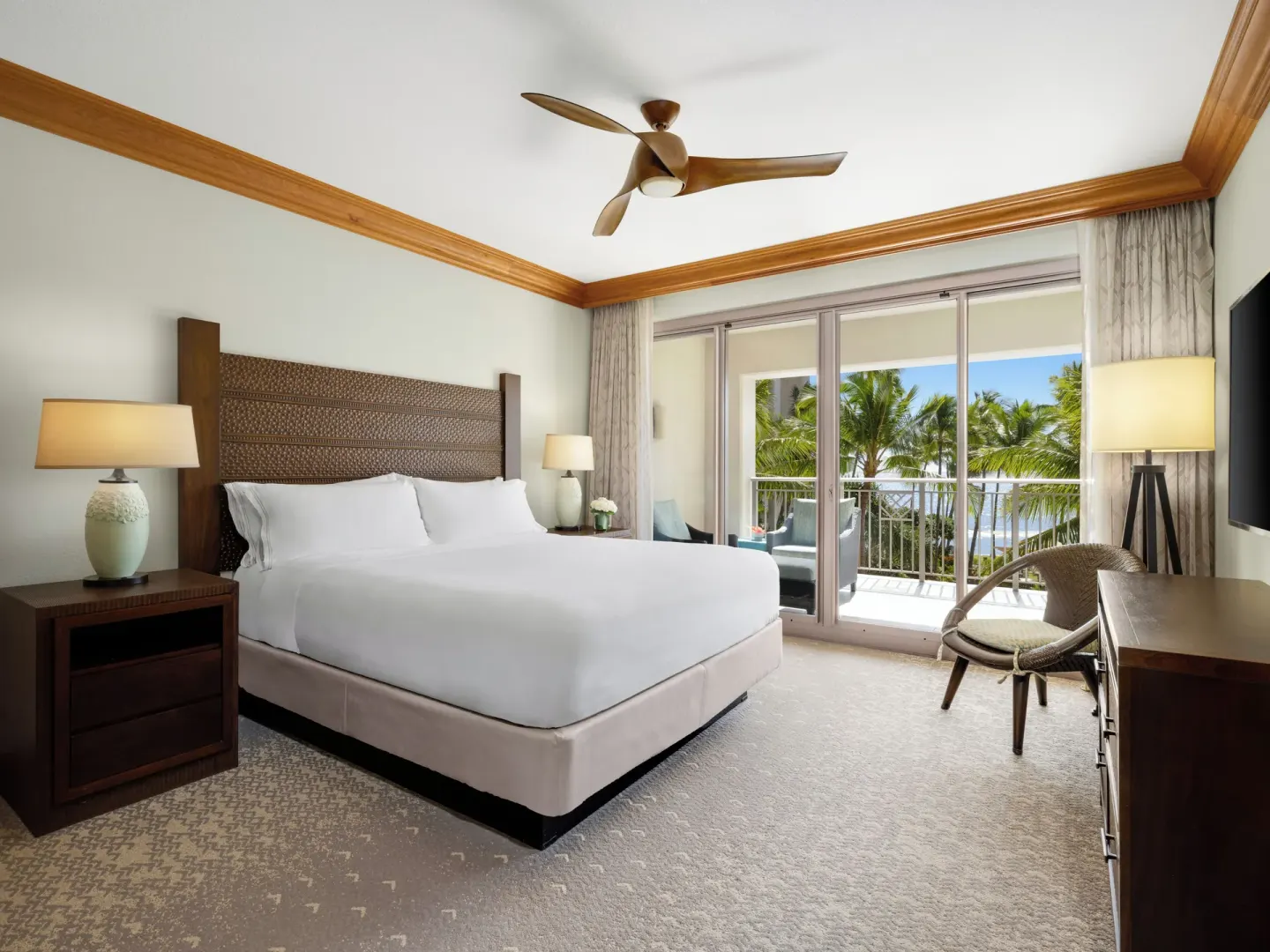 Guest room with king bed, balcony, and palm views at Hyatt Vacation Club at Ka'anapali Beach.