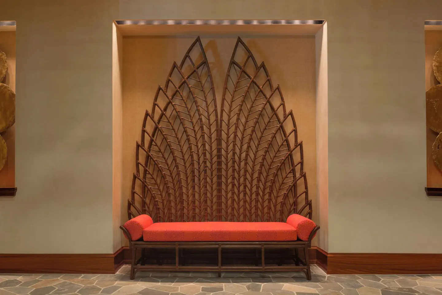 Decorative lobby bench with leaf-pattern wall art at Hyatt Vacation Club at Ka'anapali Beach.