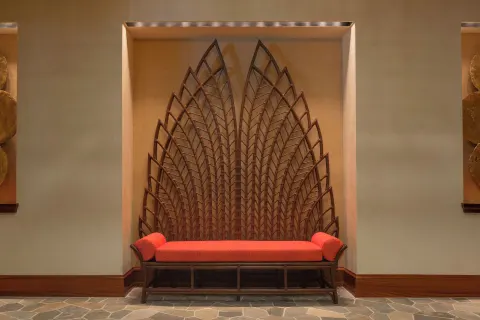 Decorative lobby bench with leaf-pattern wall art at Hyatt Vacation Club at Ka'anapali Beach.