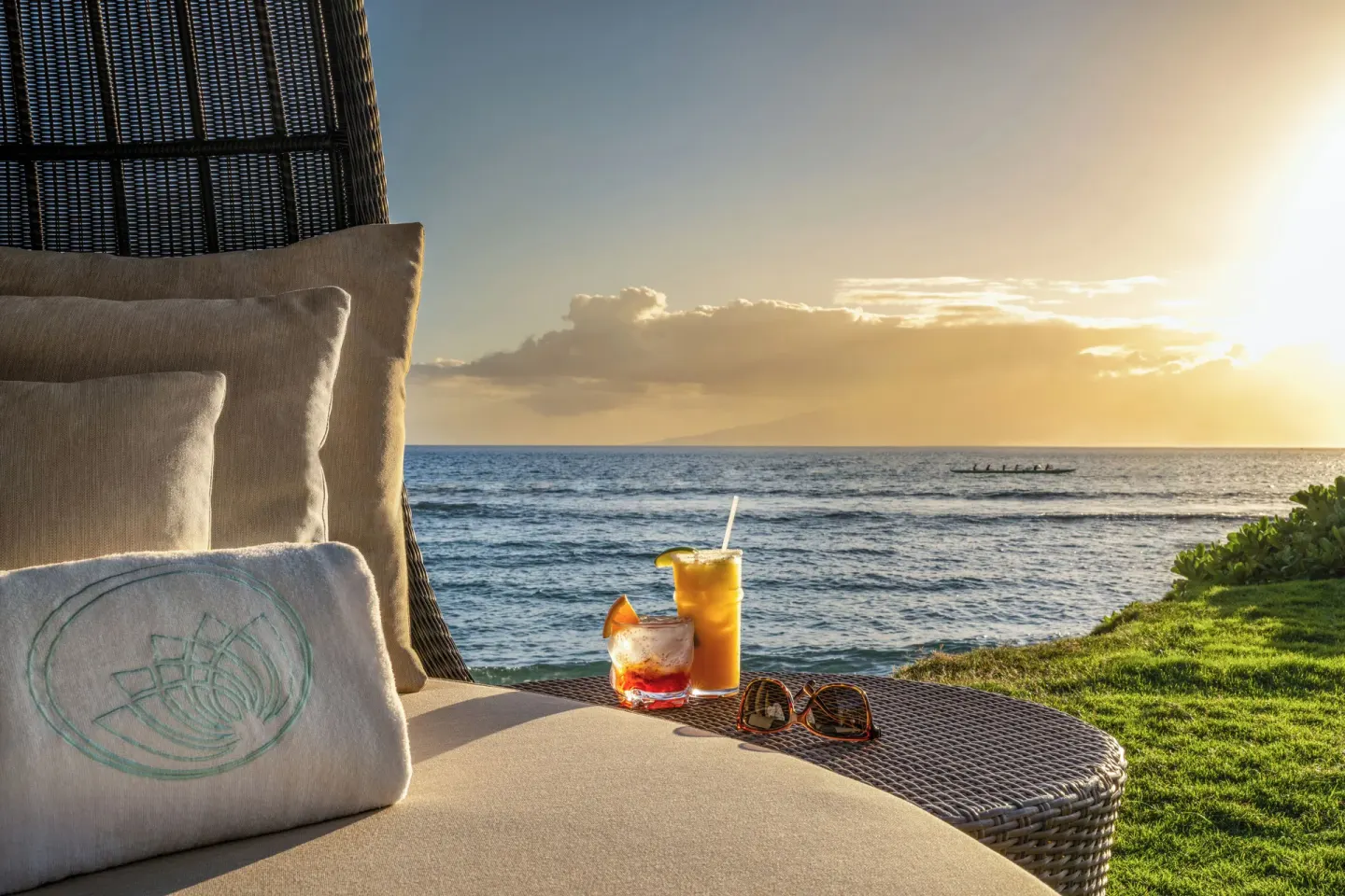 Oceanfront lounge chair with drinks at sunset at Hyatt Vacation Club at Ka'anapali Beach.