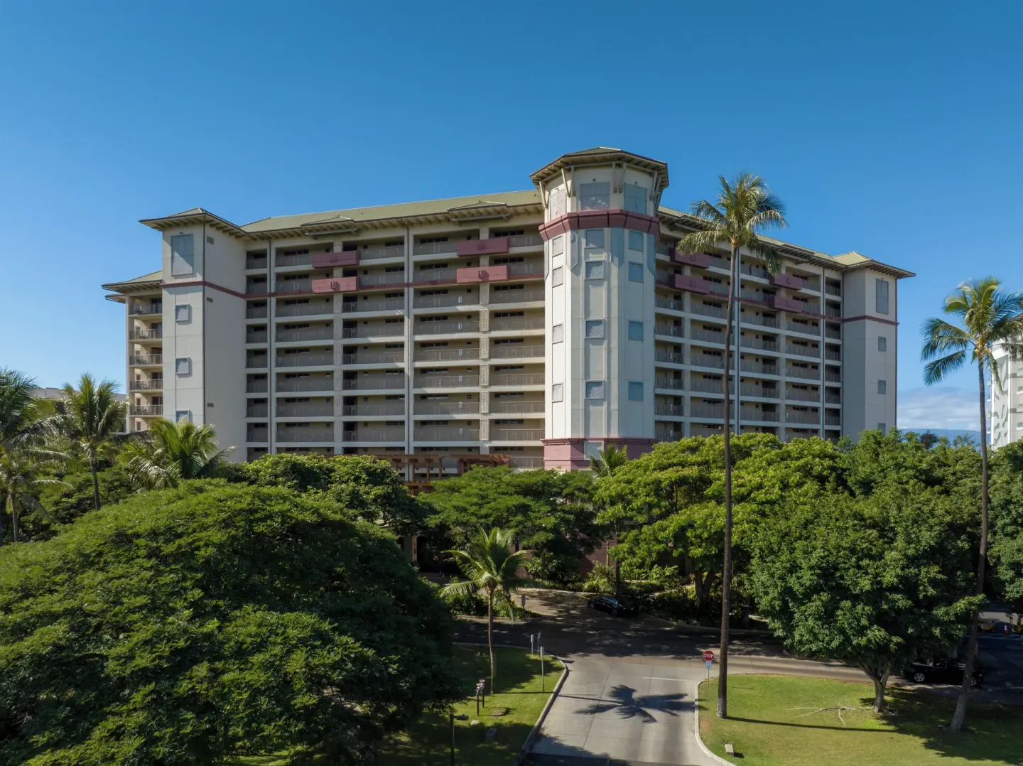 Resort tower entrance area framed by trees at Hyatt Vacation Club at Ka'anapali Beach.