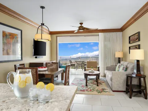 Living and dining area with balcony view at Hyatt Vacation Club at Ka'anapali Beach.