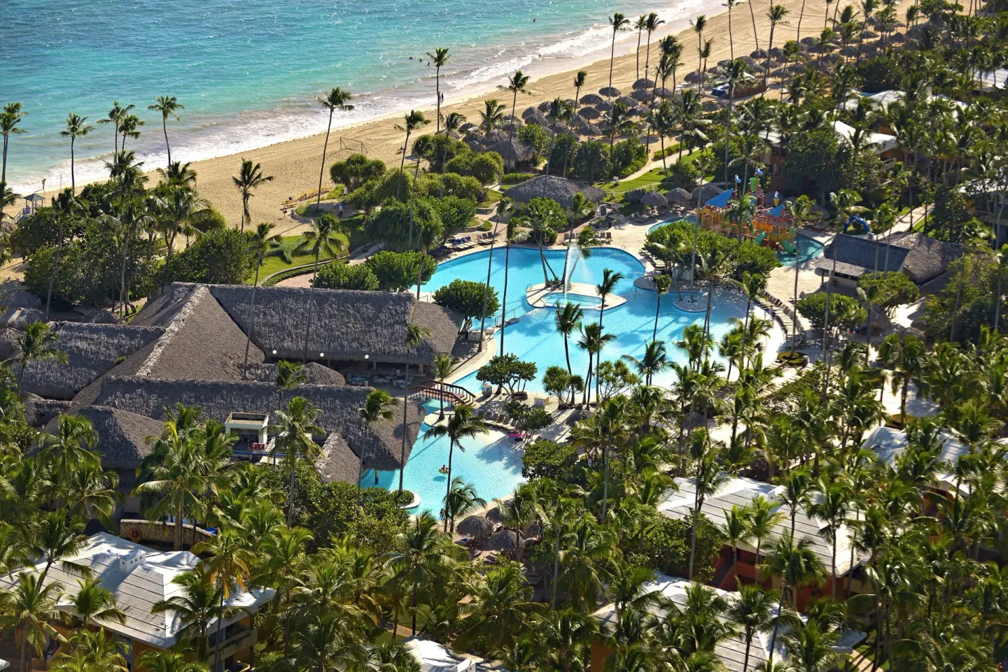 Aerial view of pools, palms, and beachfront at Iberostar Selection Bávaro Suites.