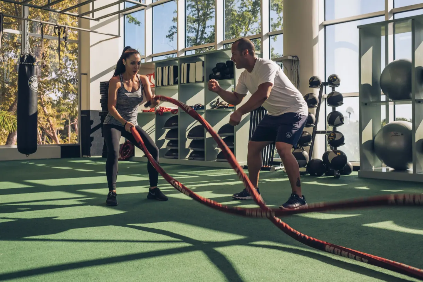 Trainer coaching battle-rope exercise at Iberostar Selection Bávaro Suites.