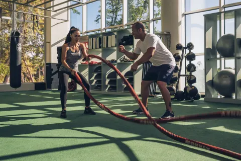 Trainer coaching battle-rope exercise at Iberostar Selection Bávaro Suites.