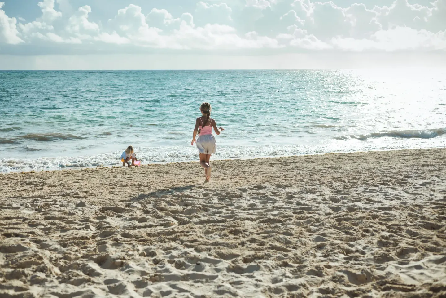 Children playing by the shoreline at Iberostar Selection Bávaro Suites.