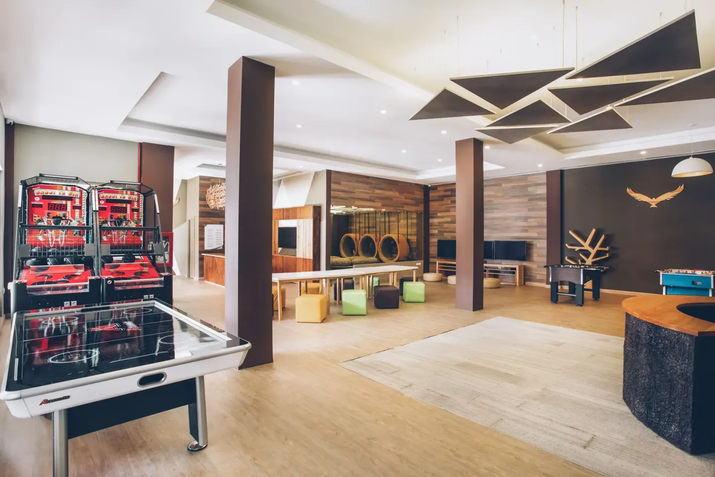 Game room with air hockey, arcade basketball and billiards at Iberostar Selection Bávaro Suites.
