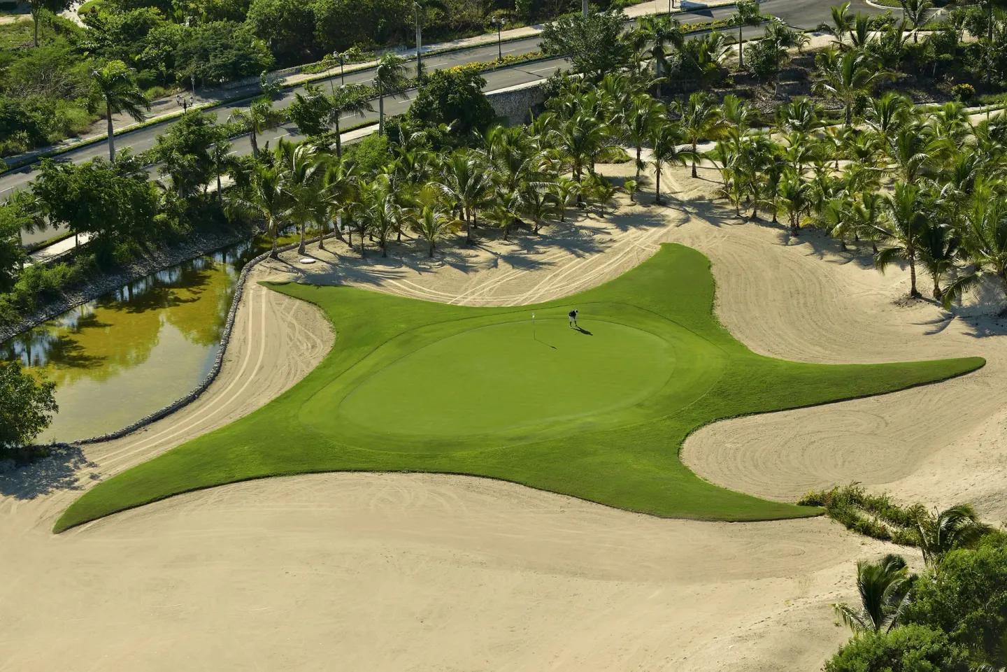 Aerial view of a golf green and sand bunkers at Iberostar Selection Bávaro Suites.