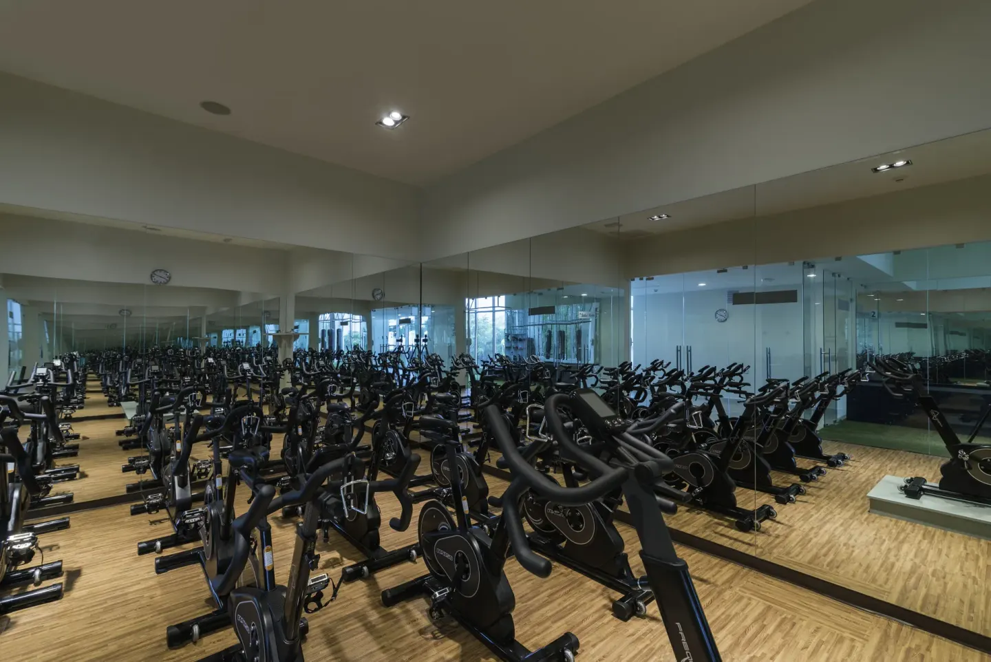 Indoor cycling studio with mirrored walls at Iberostar Selection Bávaro Suites.