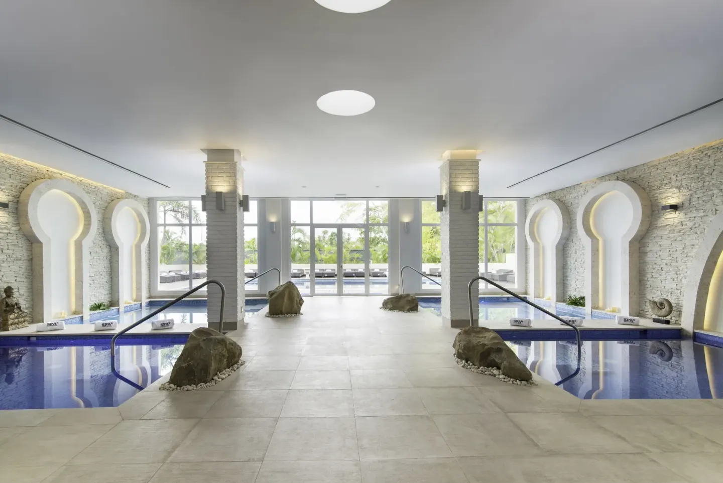Indoor hydrotherapy pools and arched alcoves at Iberostar Selection Bávaro Suites.