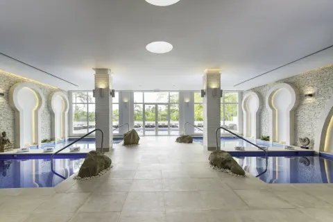 Indoor hydrotherapy pools and arched alcoves at Iberostar Selection Bávaro Suites.
